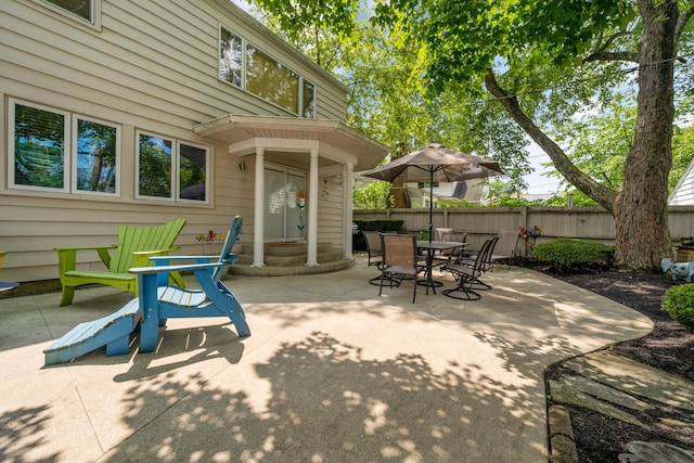 view of patio / terrace featuring fence, outdoor dining area, and entry steps