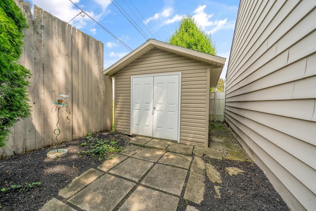 view of shed with fence
