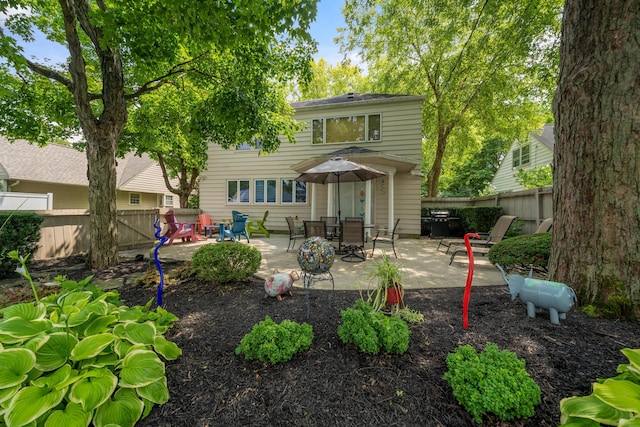 back of house with fence and a patio area