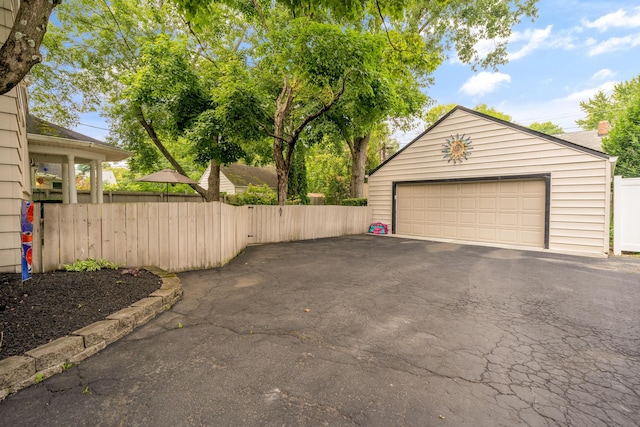 detached garage featuring fence