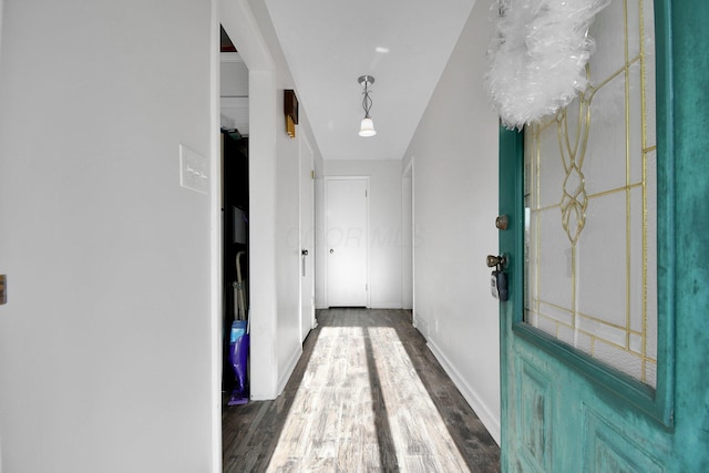 hall with baseboards and dark wood-style flooring