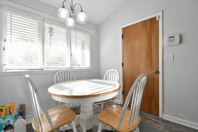 dining room with an inviting chandelier, wood finished floors, baseboards, a baseboard radiator, and vaulted ceiling