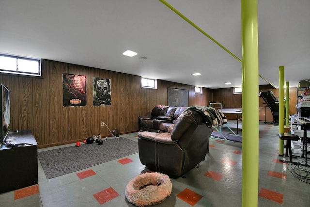 living room featuring wooden walls and tile patterned floors