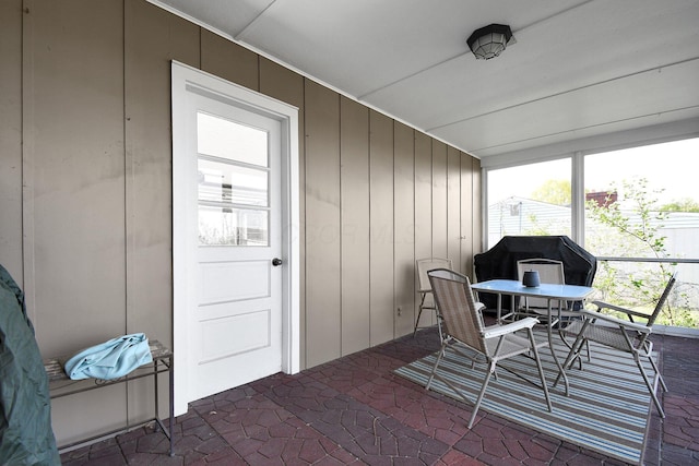 sunroom / solarium featuring outdoor dining area