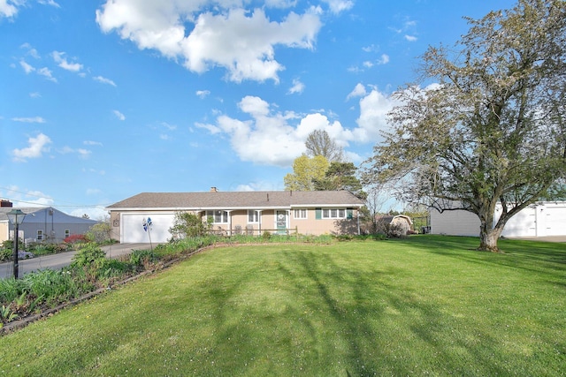 ranch-style house with a garage, driveway, and a front yard
