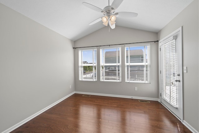 unfurnished room with vaulted ceiling, a ceiling fan, wood finished floors, and visible vents