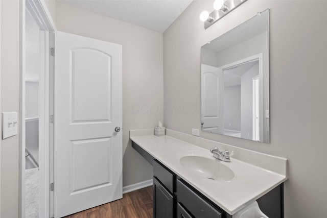 bathroom featuring vanity and wood finished floors