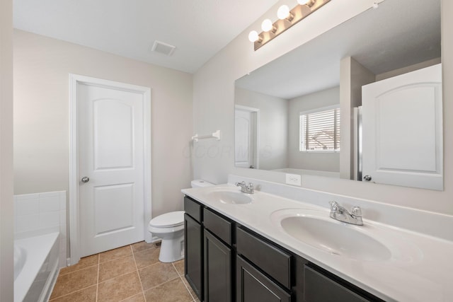 full bath featuring double vanity, a sink, a tub, and toilet