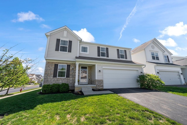 traditional-style home featuring an attached garage, a front yard, stone siding, and aphalt driveway