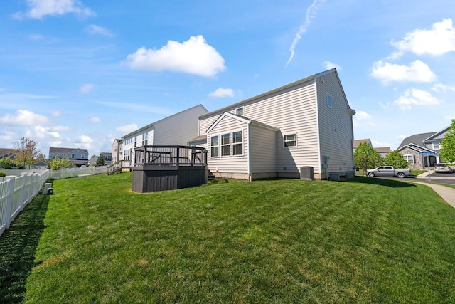 rear view of house with a yard, central AC, fence, and a wooden deck