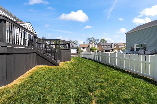 view of yard featuring stairway, fence, a residential view, and a deck