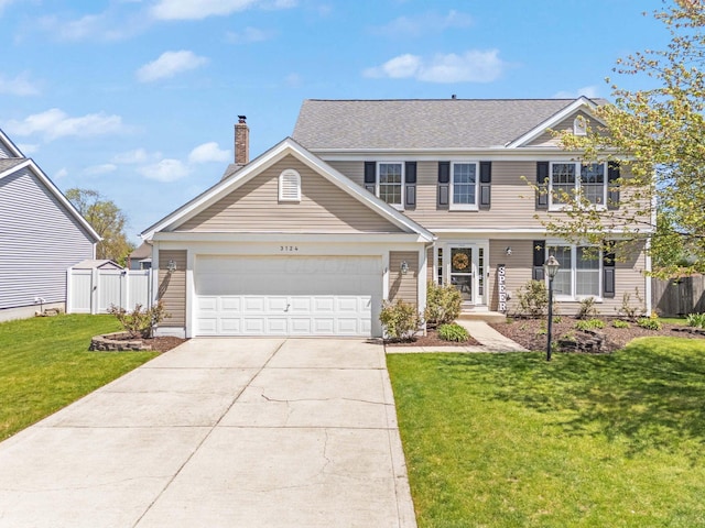 view of front facade featuring a garage, a front lawn, fence, a chimney, and driveway