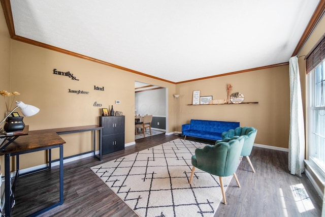living area featuring crown molding, baseboards, and wood finished floors