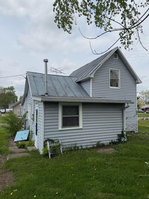 view of property exterior with a lawn