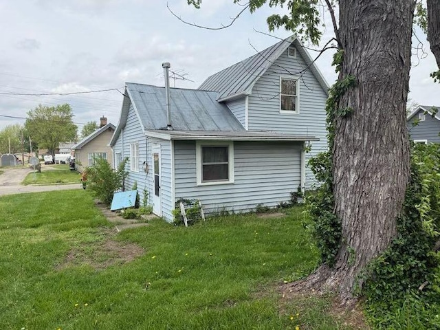 view of home's exterior with a yard