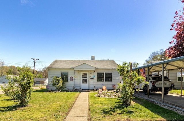 bungalow featuring roof with shingles, a chimney, and a front lawn