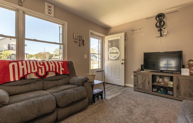 carpeted living room featuring baseboards
