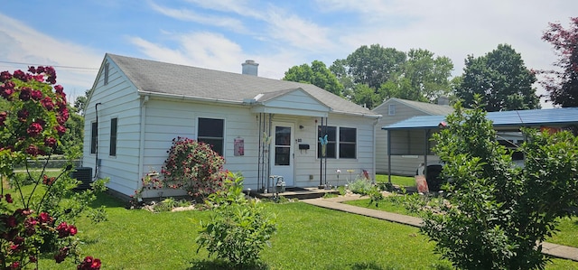 956 Harrison Ave, Lancaster, OH 43130 - bungalow-style house with a chimney, a carport, and roof with shingles