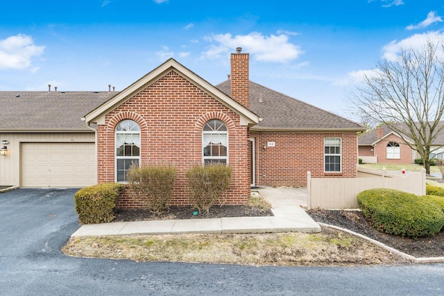 94 Potters Shed Dr Unit 11, Reynoldsburg, OH 43068 - ranch-style home with brick siding, a garage, driveway, and a chimney