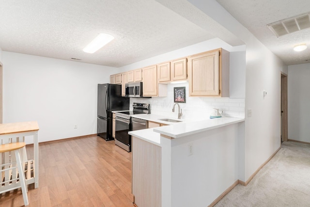 94 Potters Shed Dr Unit 11, Reynoldsburg, OH 43068 - kitchen featuring a textured ceiling, visible vents, light brown cabinetry, appliances with stainless steel finishes, and a sink