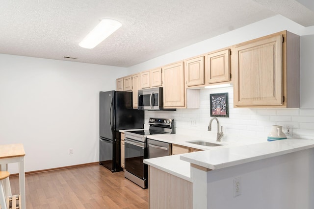 94 Potters Shed Dr Unit 11, Reynoldsburg, OH 43068 - kitchen with a textured ceiling, light brown cabinetry, tasteful backsplash, a sink, and stainless steel appliances