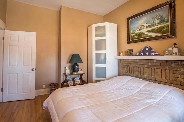 bedroom featuring baseboards and wood finished floors