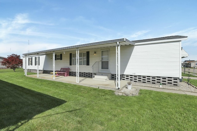 rear view of house featuring a yard, entry steps, and a patio
