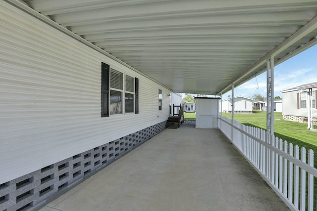 view of patio / terrace with fence and an attached carport