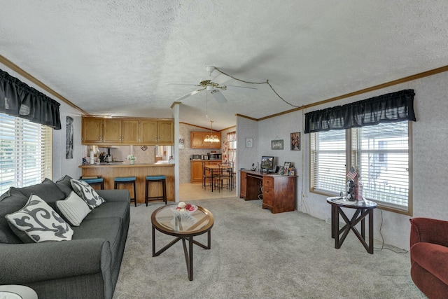 living room featuring vaulted ceiling, ceiling fan, ornamental molding, and a textured ceiling