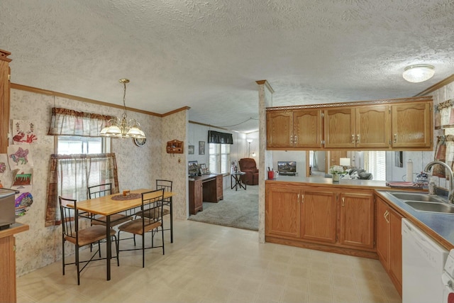 kitchen featuring a sink, crown molding, white dishwasher, and wallpapered walls