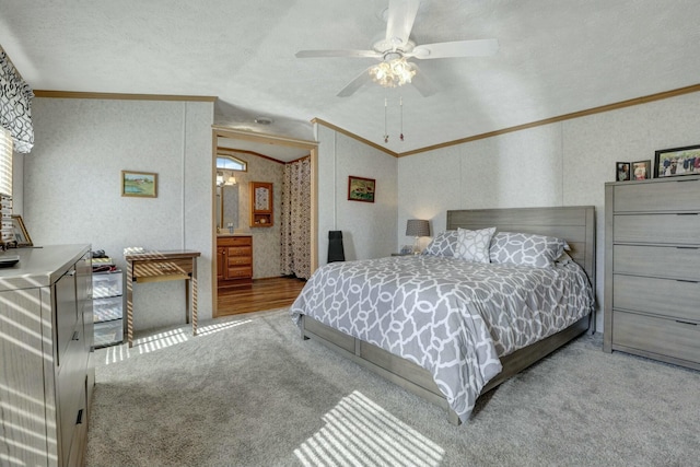carpeted bedroom with crown molding, lofted ceiling, and ceiling fan
