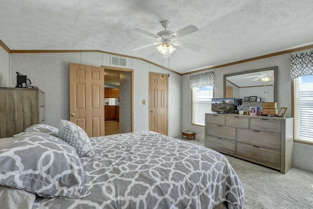 bedroom with crown molding, a textured ceiling, visible vents, and carpet