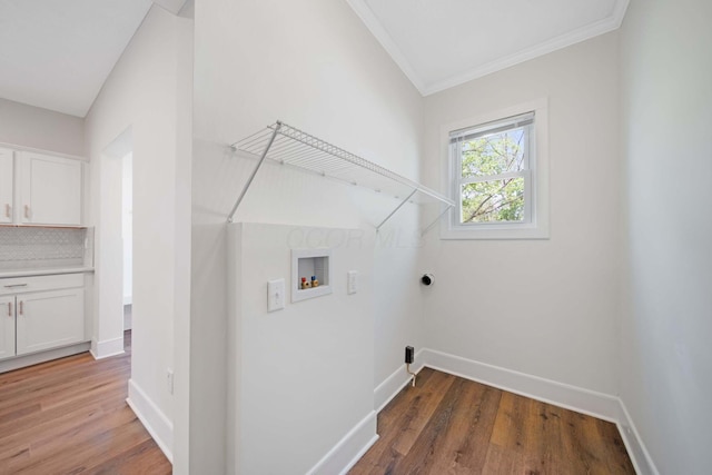 laundry area with baseboards, laundry area, hookup for a washing machine, and wood finished floors