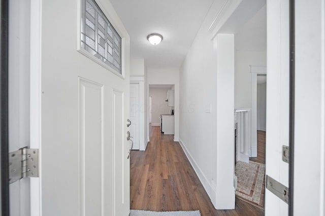 corridor with baseboards and dark wood-style floors