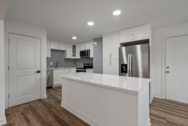 2671 Whitehead Rd, Columbus, OH 43204 - kitchen featuring dark wood-style flooring, tasteful backsplash, white cabinets, and stainless steel appliances