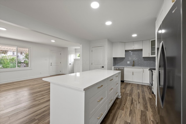2671 Whitehead Rd, Columbus, OH 43204 - kitchen featuring a kitchen island, dark wood-style floors, a sink, backsplash, and stainless steel appliances