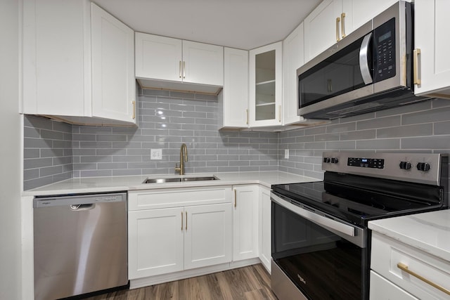 2671 Whitehead Rd, Columbus, OH 43204 - kitchen with light countertops, a sink, white cabinets, and stainless steel appliances