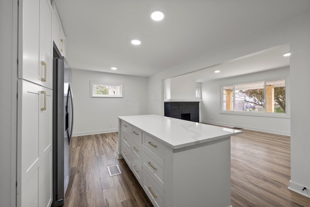 2671 Whitehead Rd, Columbus, OH 43204 - kitchen with baseboards, plenty of natural light, a center island, and white cabinetry