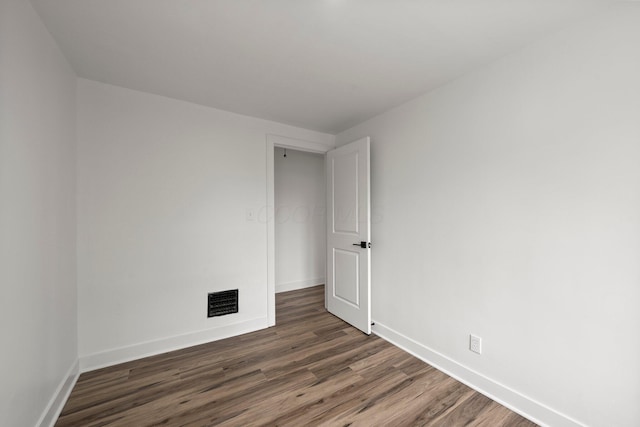 2671 Whitehead Rd, Columbus, OH 43204 - empty room featuring baseboards, dark wood-style flooring, and visible vents