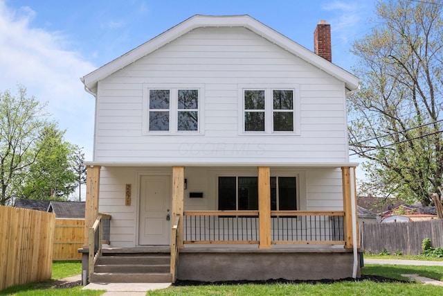 2671 Whitehead Rd, Columbus, OH 43204 - view of front of house with covered porch, fence, a chimney, and a front yard