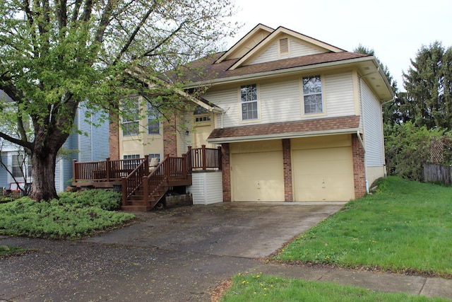 view of front of property with an attached garage, a front yard, driveway, and brick siding