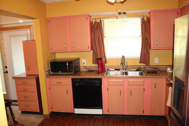 kitchen featuring red cabinets, a ceiling fan, dark wood-style flooring, appliances with stainless steel finishes, and a sink