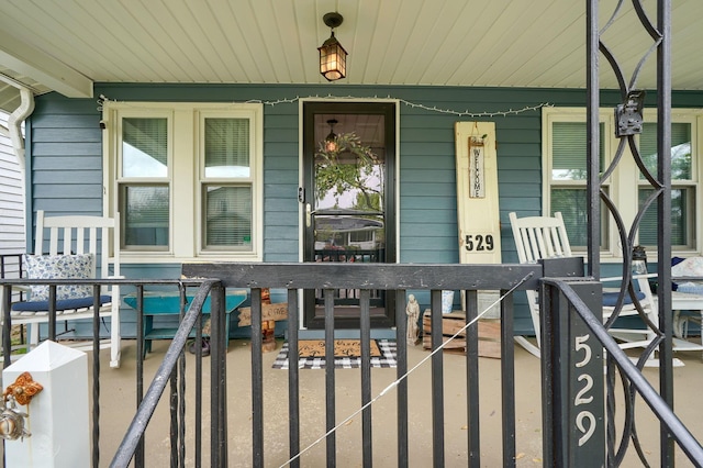 view of exterior entry featuring a porch