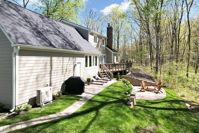 view of yard with a wooden deck, ac unit, stairs, and a patio area