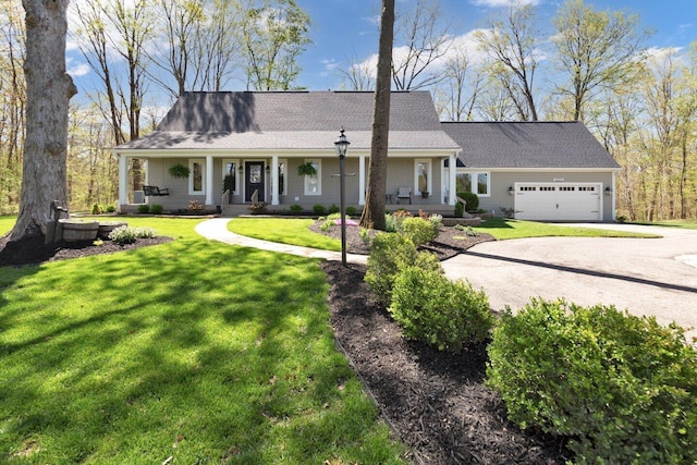 view of front of home with a garage, covered porch, a front yard, and concrete driveway