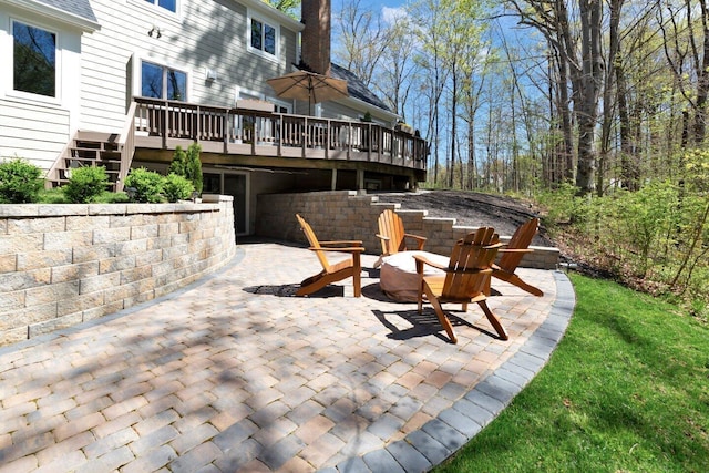 view of patio featuring stairs, a fire pit, and a wooden deck