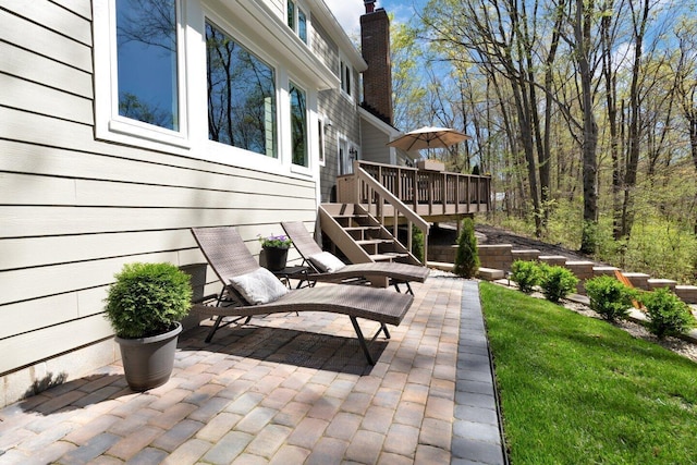 view of patio / terrace featuring a deck and stairs