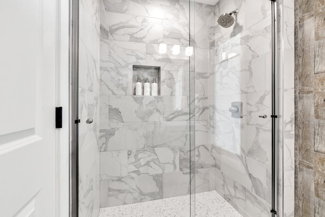 bathroom with a marble finish shower