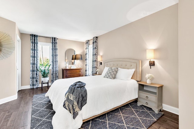 bedroom with baseboards and wood finished floors