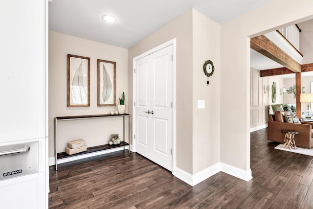entrance foyer with baseboards and dark wood-style flooring